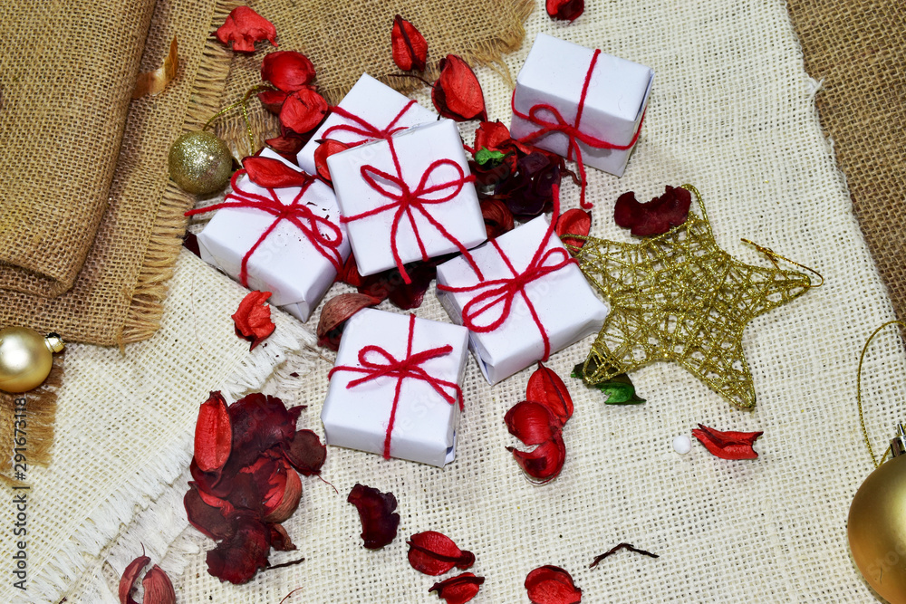 Small gift box, white box tied with a red bow adorned with a golden ball 6. In preparation for the celebration of Christmas, New Year, weddings, birthdays. Small gift box, white box tied with a red bow adorned with a golden ball 6. In preparation for the celebration of Christmas, New Year, weddings, birthdays.