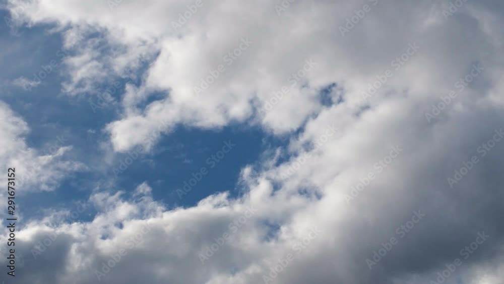 White and Dark Cumulus Clouds Flowing Fast in Blue Sky. White and Dark Cumulus Clouds Flowing Fast in Blue Sky.