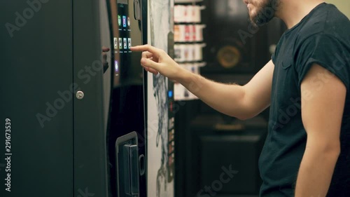 Young Man Buying Coffee Vending Machine