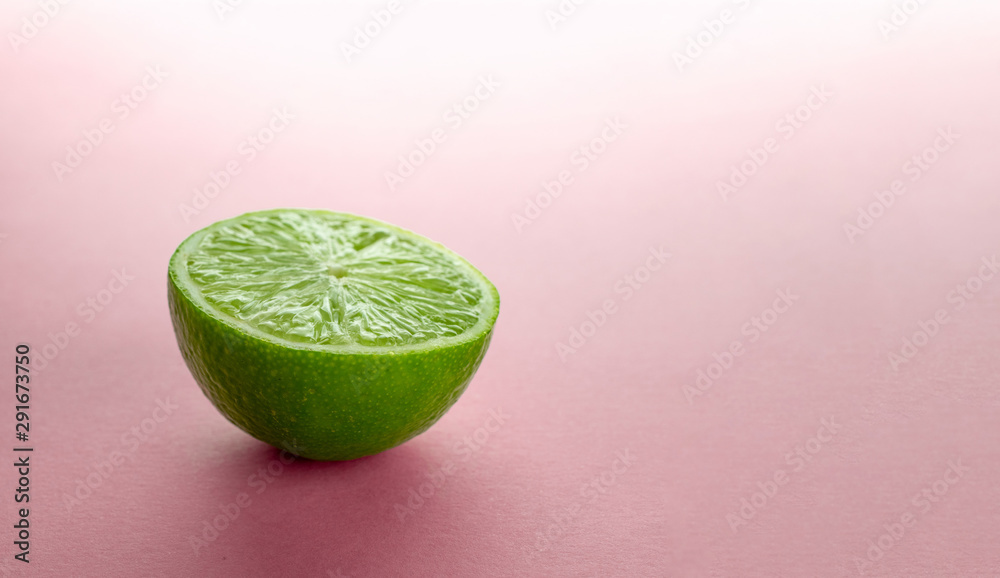 Lime slice. Green background. Fresh juicy green lime isolated on