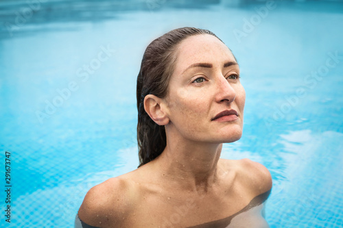 Beautiful woman swimming naked in a swimming pool © merla