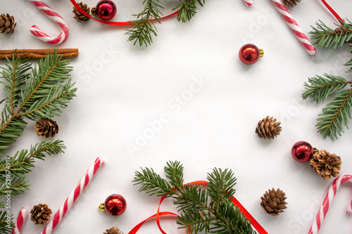Christmas top view background with sugar cane, small cones and Christmas tree toys with copy space