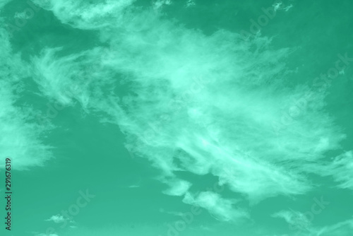 Green toned abstract background with cloud in the sky. Color of spring-summer 2020