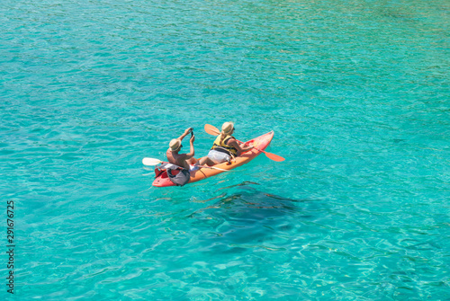 Couple of adult on a kayak in a clear sea
