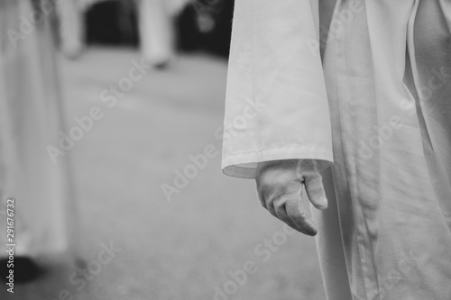 Close up of a white glove in a procession, Holy Week
