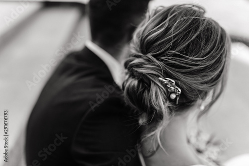 the groom embraces the bride