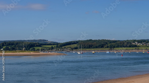 Sunny day view of the river Exe estuary at Exmouth, with assorted unidentifiable boats moored. Devon, England.