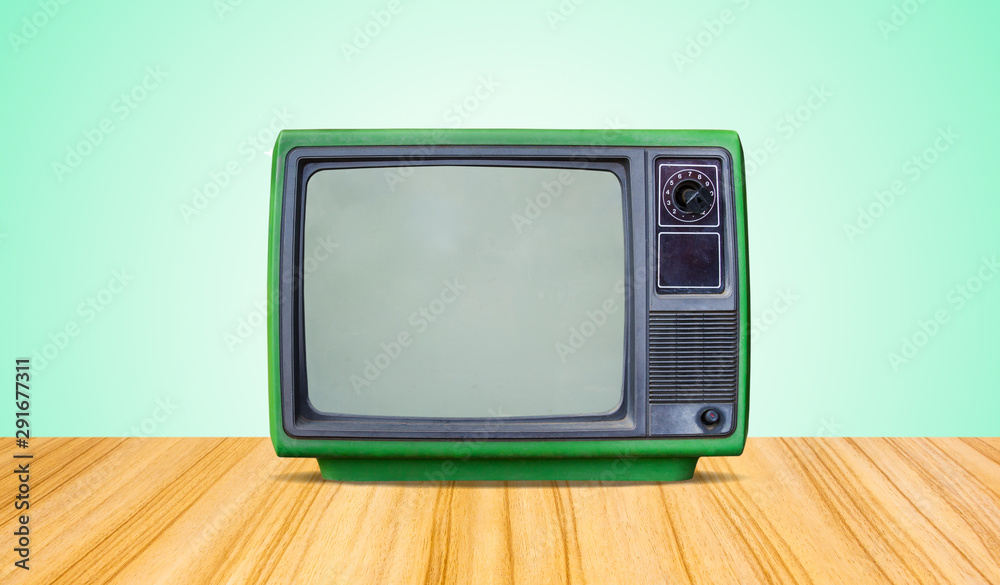 green retro old television receiver on table front gradient green wall background.