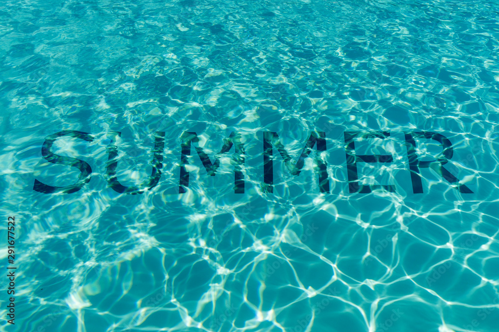 Word Summer underwater on the bottom of a swimming pool