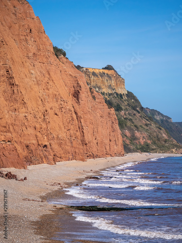 The famous Jurassic Coast red cliffs at Sidmouth, Devon, England. Looking East from Sidmouth Beach to Salcombe Hill Cliff. Vertical shot.