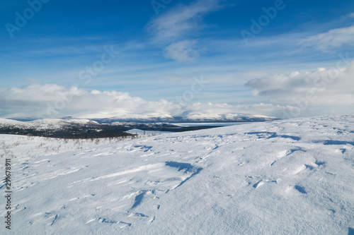 winter mountain landscape with blue sky and clouds