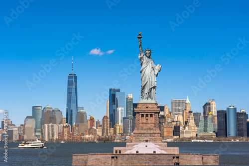 The Statue of Liberty over the New York cityscape river side which location is lower manhattan, United state of America, USA, Architecture and building with tourist concept © THANANIT