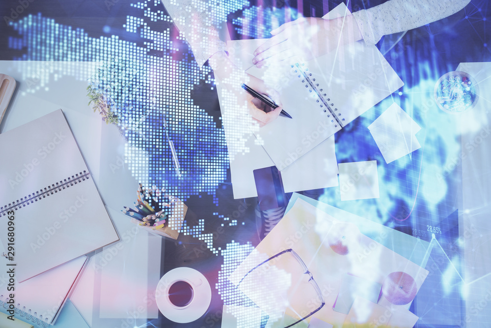 Hand taking notes in notepad. Forex chart holograms in front. Concept of research. Double exposure Hand taking notes in notepad. Forex chart holograms in front. Concept of research. Double exposure