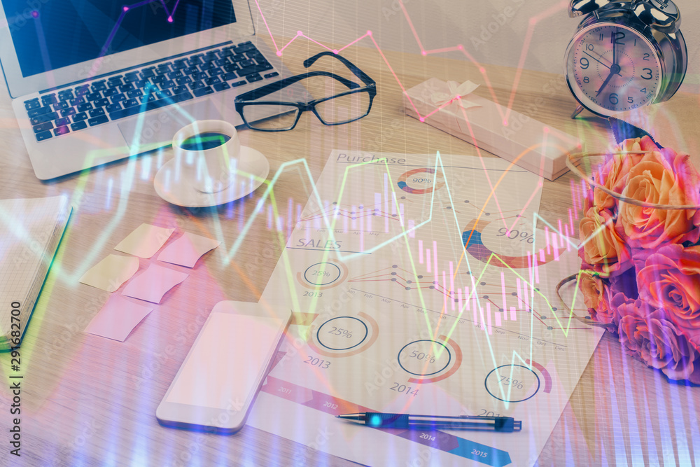 Financial chart drawing and table with computer on background. Double exposure. Concept of international markets. Financial chart drawing and table with computer on background. Double exposure. Concept of international markets.