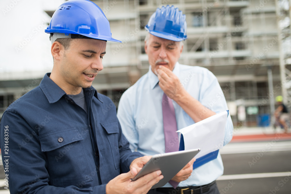 Architect talking to the site manager Architect talking to the site manager