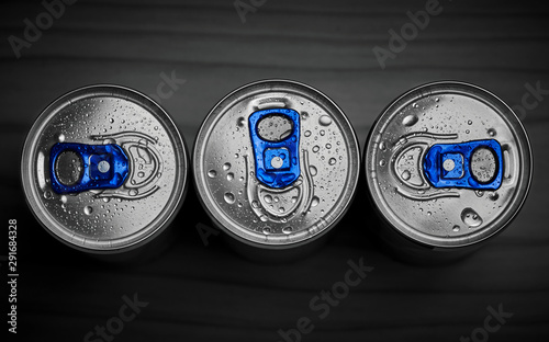 Three energy drinks on dark background , top view.