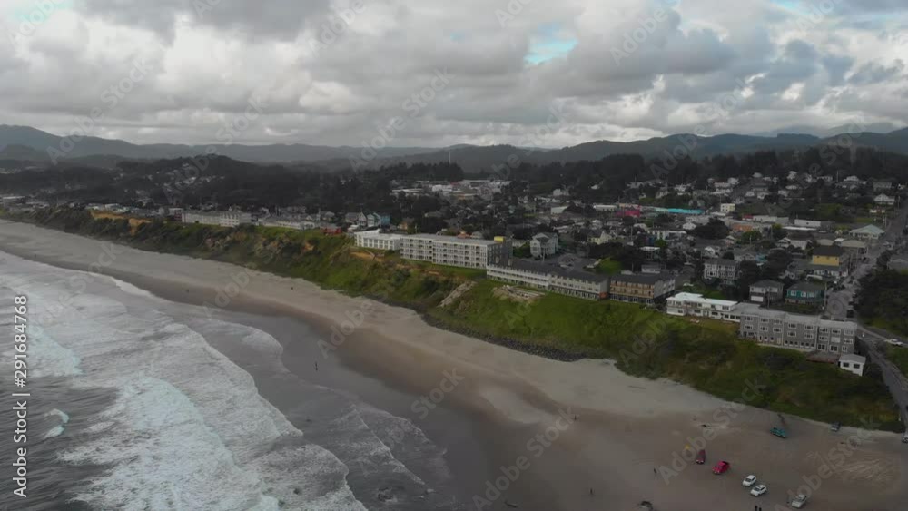 Aerial view of a white building in front of a beach on the coast of Oregon Aerial view of a white building in front of a beach on the coast of Oregon