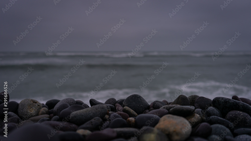 Fototapeta premium Wet stones on the seashore in Miraflores, Lima