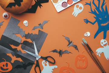 Photo of halloween backgrounds with paper ghosts, pumpkin, skulls