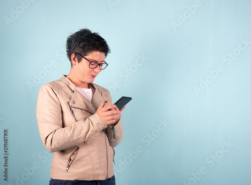 Woman take photo smartphoe selfie blue background  photo