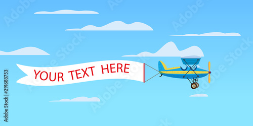 Red retro biplane aircraft pulling advertisement banner