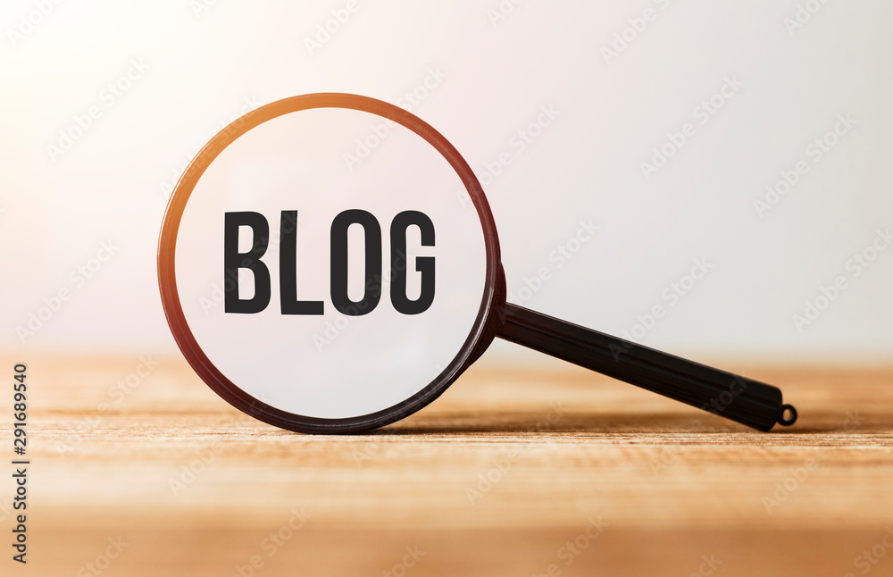 Magnifying glass with text Blog on wooden table. Magnifying glass with text Blog on wooden table.