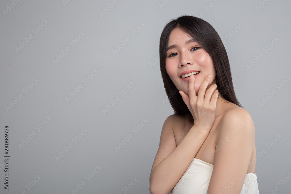 The woman wore a white strapless dress and hand touched her mouth. The woman wore a white strapless dress and hand touched her mouth.