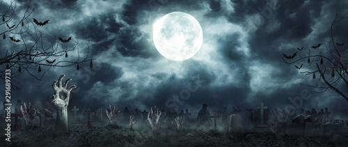 Zombie Rising and hands Out Of A Graveyard cemetery scary In Spooky dark Night full moon. Holiday event halloween concept. photo