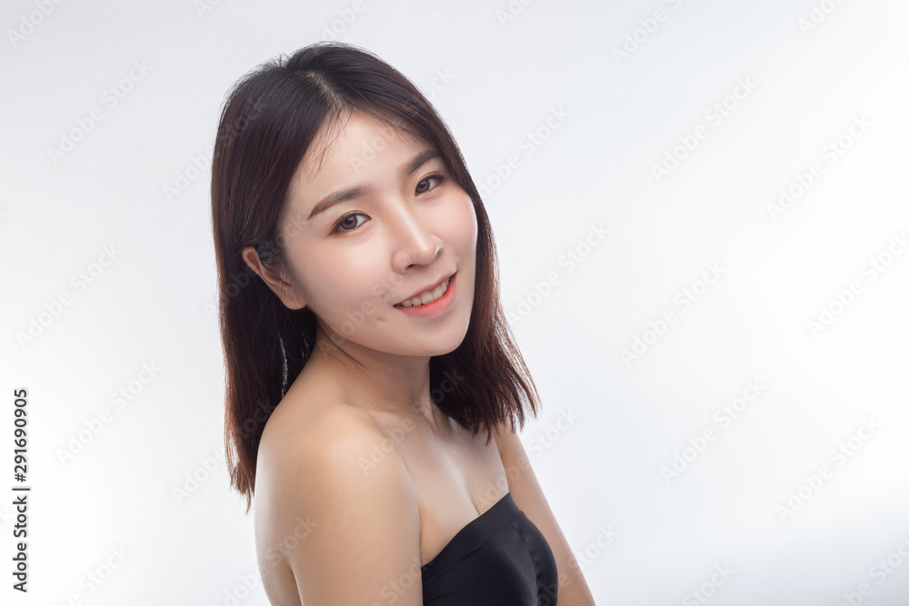 The women wear white strapless tops and face to the right. The women wear white strapless tops and face to the right.