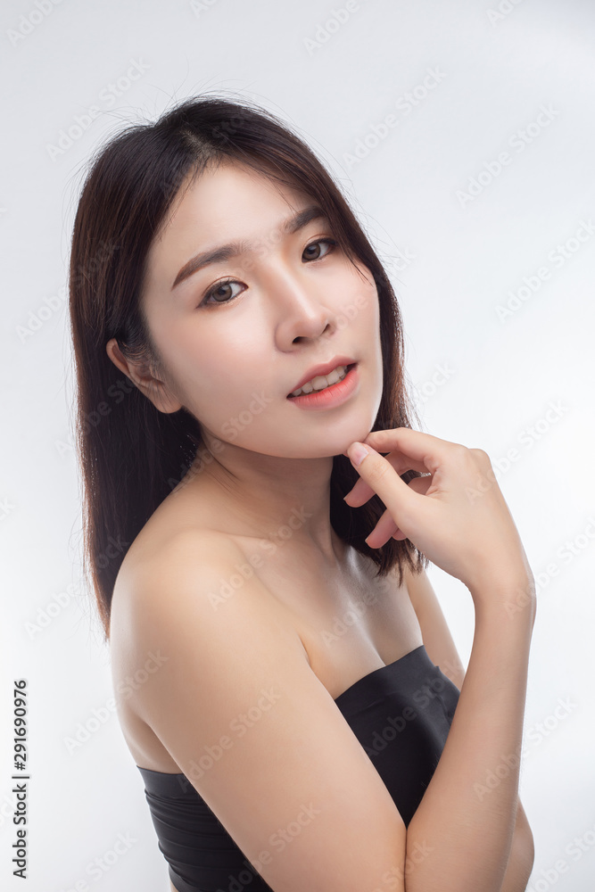 Woman wearing a black strapless dress and hands touching the chin. Woman wearing a black strapless dress and hands touching the chin.