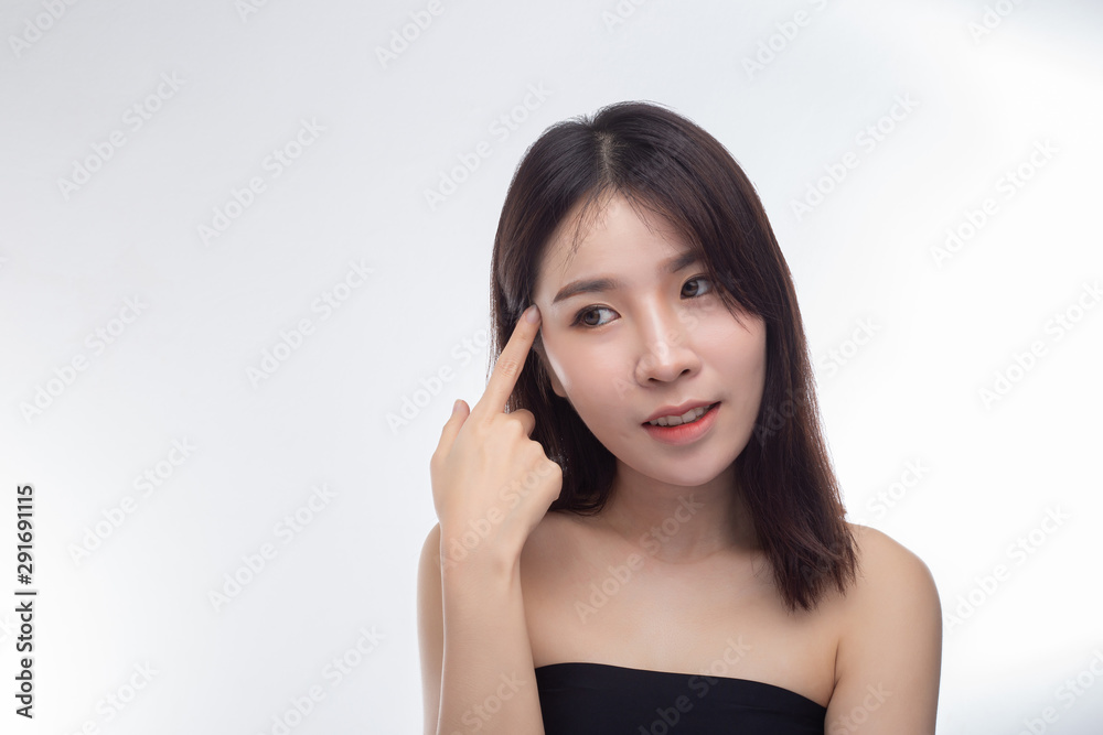 Women wearing black strapless blouses and hands touching the face on the eyebrows. Women wearing black strapless blouses and hands touching the face on the eyebrows.