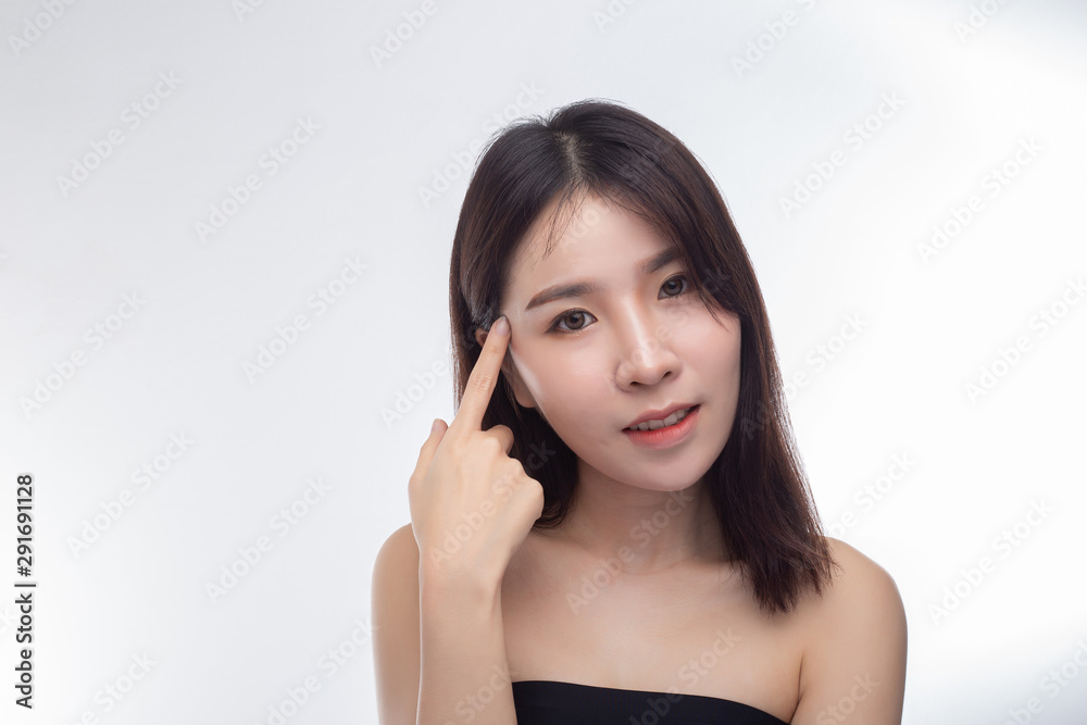 Women wearing black strapless blouses and hands touching the face on the eyebrows. Women wearing black strapless blouses and hands touching the face on the eyebrows.