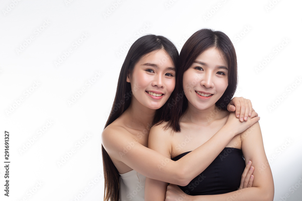 Two young women hug each other happily. Two young women hug each other happily.