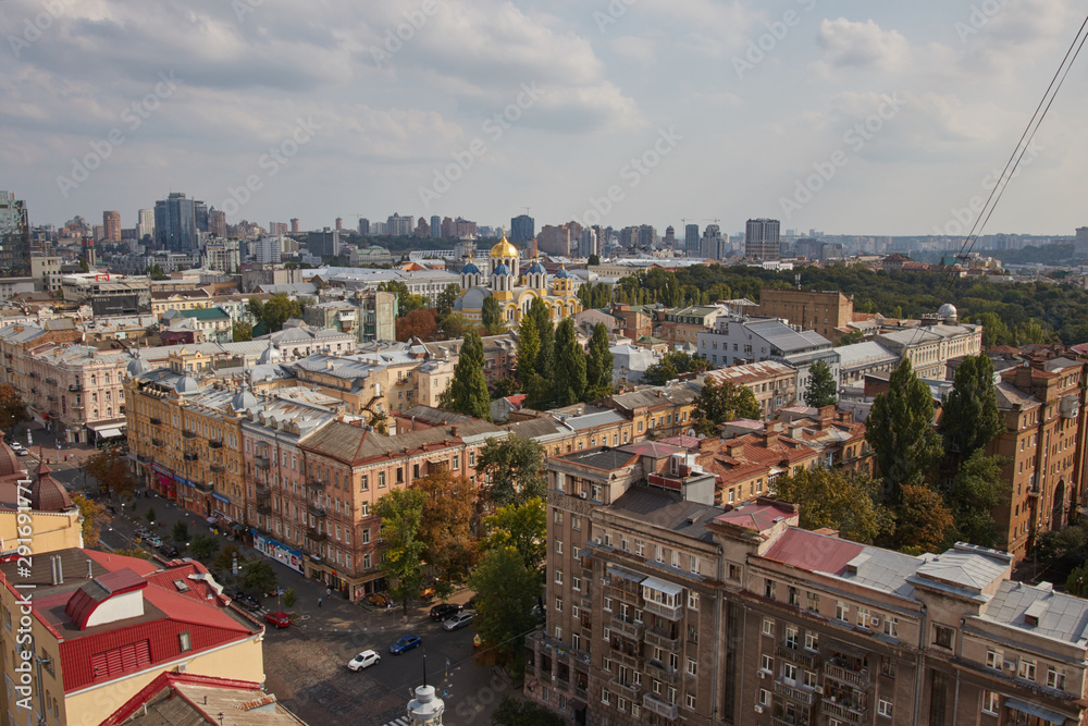 Fototapeta premium Architecture and buildings in Europe. The capital of Ukraine. Kiev city center. Street, roofs, buildings, travel, city center. Beautiful view of the city from above. Clouds over the city