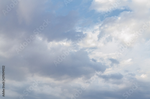 White fluffy clouds in the blue sky in summer