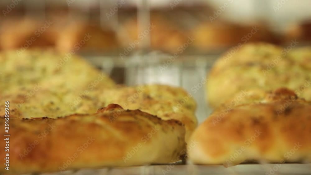 Fresh bread straight out of the oven on cooling racks. Bakery factory Fresh bread straight out of the oven on cooling racks. Bakery factory