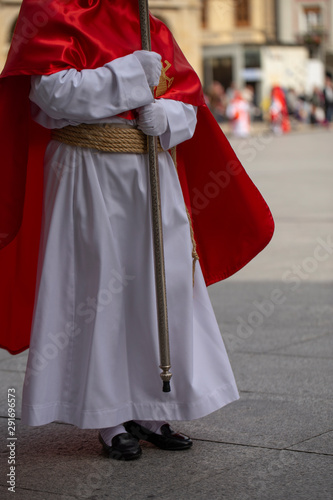Penitent holding a cross in a procession