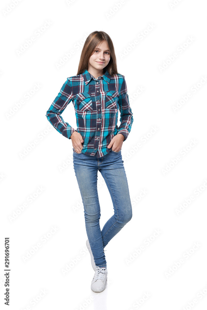 Teen girl in checkered shirt standing casually Teen girl in checkered shirt standing casually