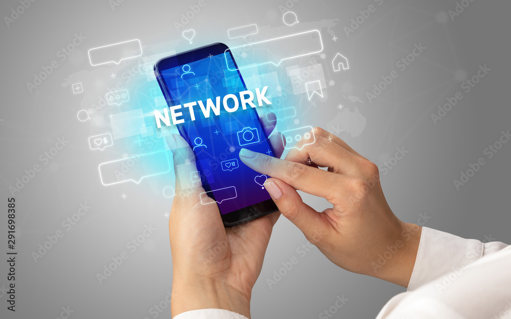 Female hand typing on smartphone with NETWORK inscription, social media concept Female hand typing on smartphone with NETWORK inscription, social media concept