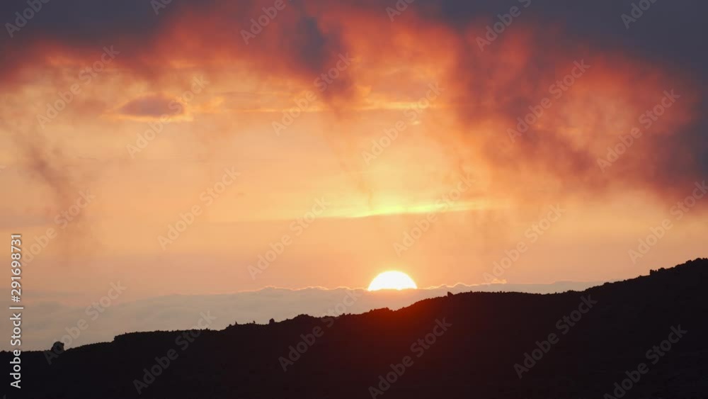 Dramatic Sunset over the Storm Clouds. Time Lapse. The dramatic landscape of sky and curly clouds. Dramatic Sunset over the Storm Clouds. Time Lapse. The dramatic landscape of sky and curly clouds.