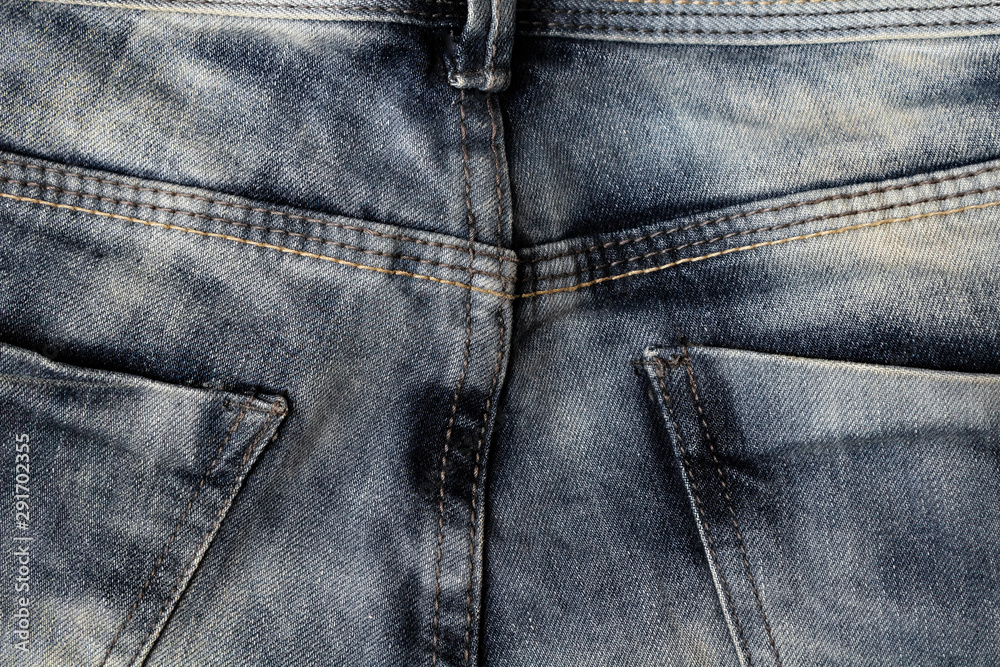 pockets and rough double stitches on jeans close-up, fashionable shabby denim texture pockets and rough double stitches on jeans close-up, fashionable shabby denim texture