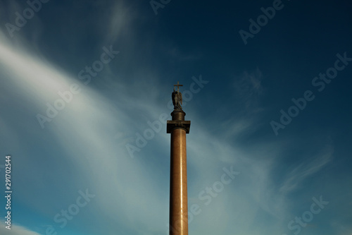 World heritage concept. Beautiful view on Alexandrian Column at Palace Square in Saint Petersburg. Sunny cloudy weather. Text space. Outdoor shot