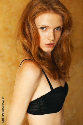 Underwear, lingerie concept. Portrait of fashionable model with red  (ginger) wavy hair, natural make-up. Perfect skin with freckles. Retro  style. Close up. Studio shot Stock Photo | Adobe Stock