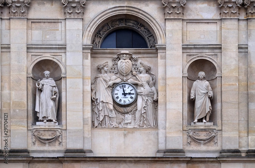 St. Thomas Aquinas, Pierre Lombard, muses support the clock, topped by the coat of arms of Cardinal Richelieu, facade of the St Ursule chapel of the Sorbonne in Paris photo