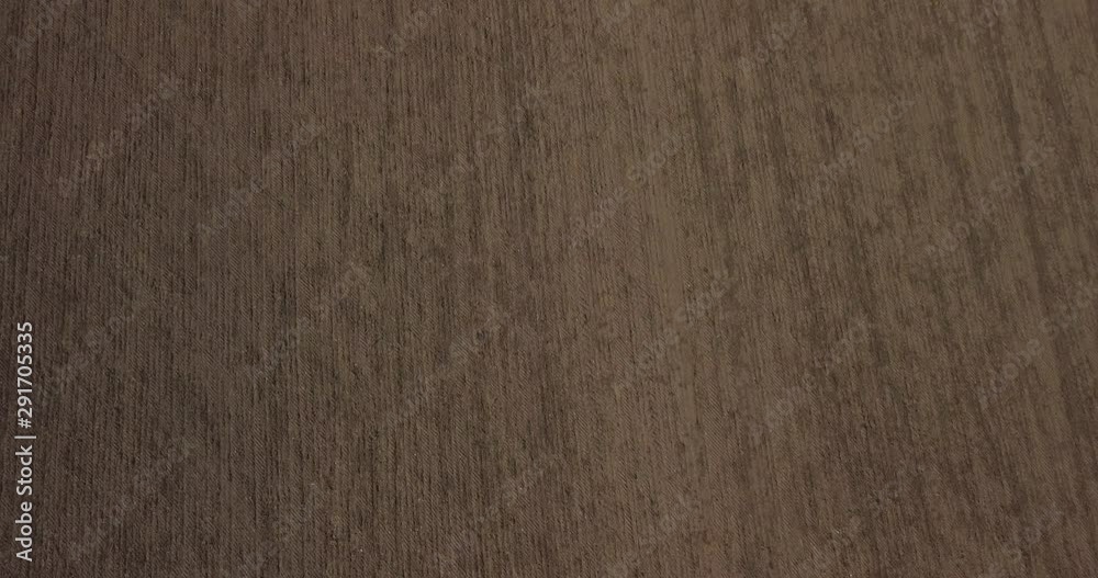 Aerial view of ploughed fields.  Slow tilt up to landscape.
