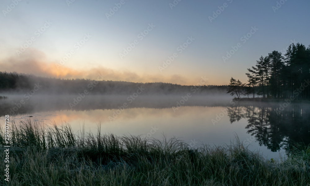 Scenic view from swamp , morning landscape with fog over a small forest lake and swamp  at autumn morning, frost, beautiful reflections, Driskina lake, Raiskums parish, Latvia