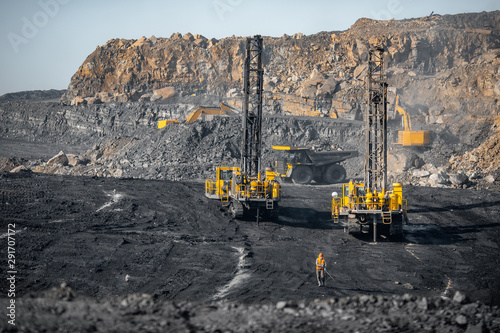 Drilling machine rigs borer wells for installing cast explosives blasting. Open mine coal and minerals from bowels soil explosion