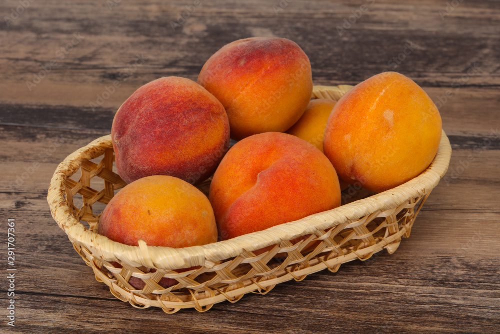 Peach heap in the wooden basket Peach heap in the wooden basket