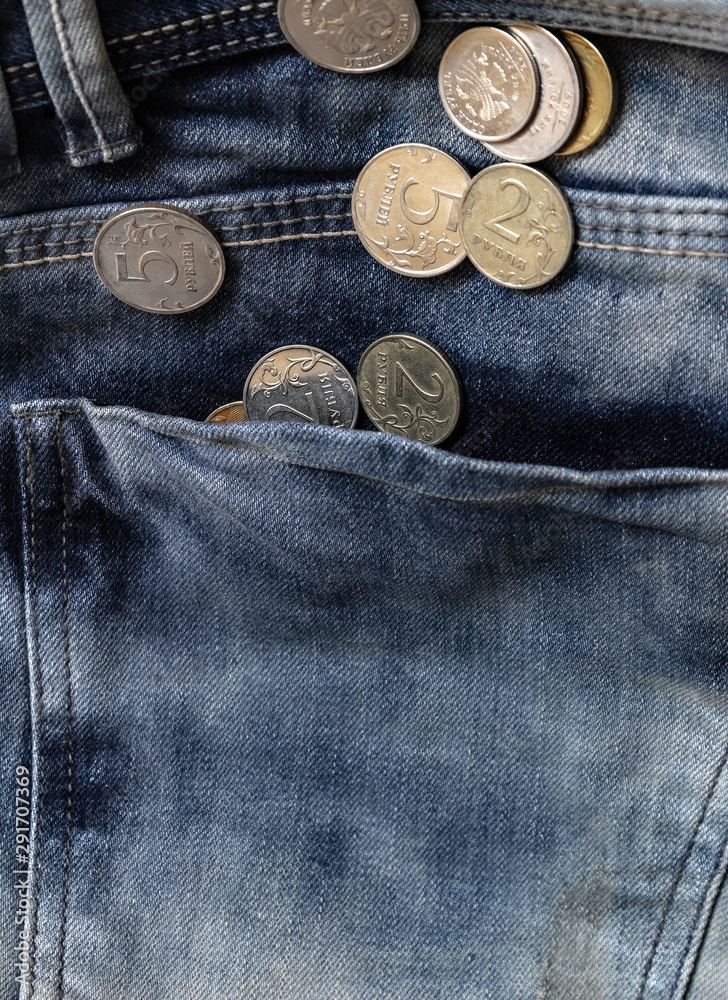 coins in jeans pocket close-up, finance and currency concept coins in jeans pocket close-up, finance and currency concept