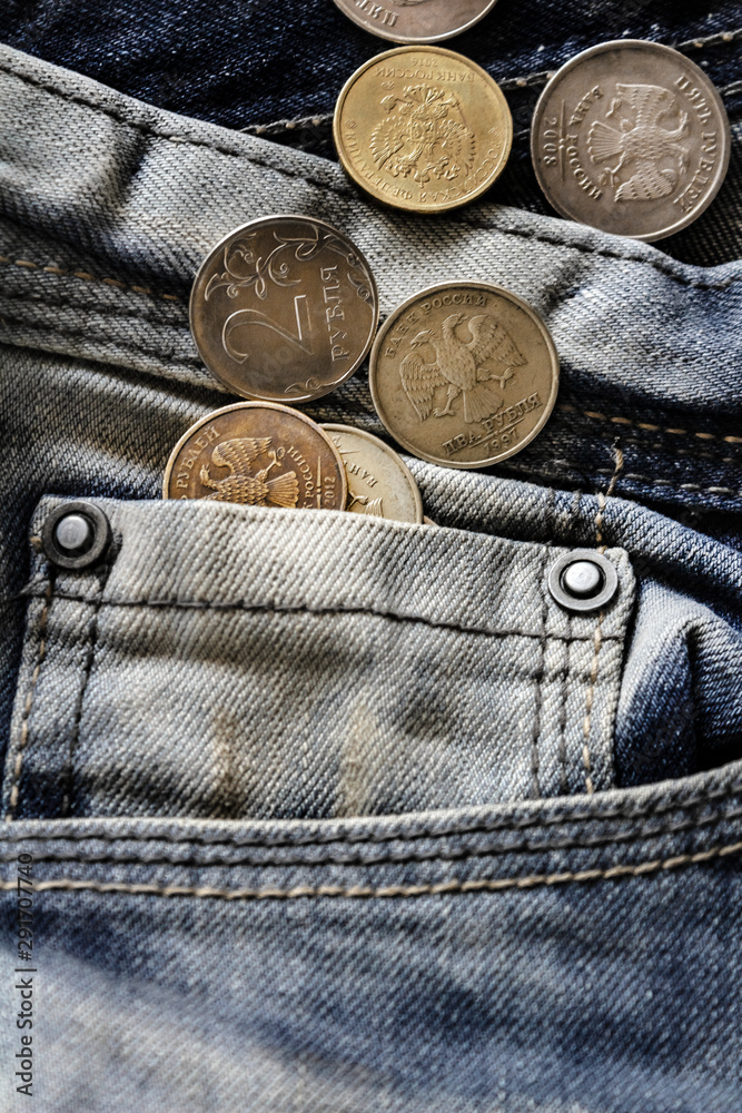 coins in jeans pocket close-up, finance and currency concept coins in jeans pocket close-up, finance and currency concept